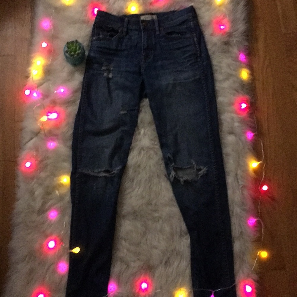 Dark wash women’s jeans with fading and rips